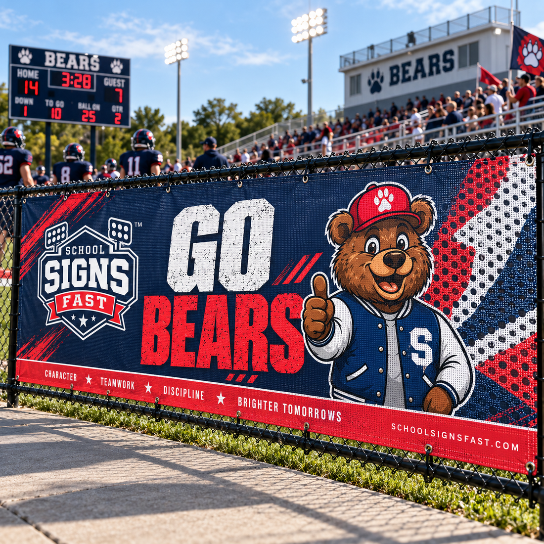 Navy and red Go Bears mesh banner on a stadium chain-link fence with fans in the stands