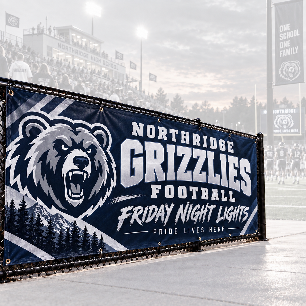 Navy vinyl sports banner with a bear mascot and grommets on a high school football stadium fence