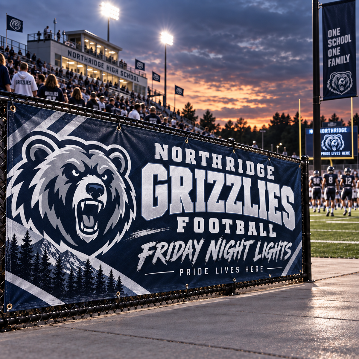Navy bear-mascot football banner hung on a stadium fence at dusk